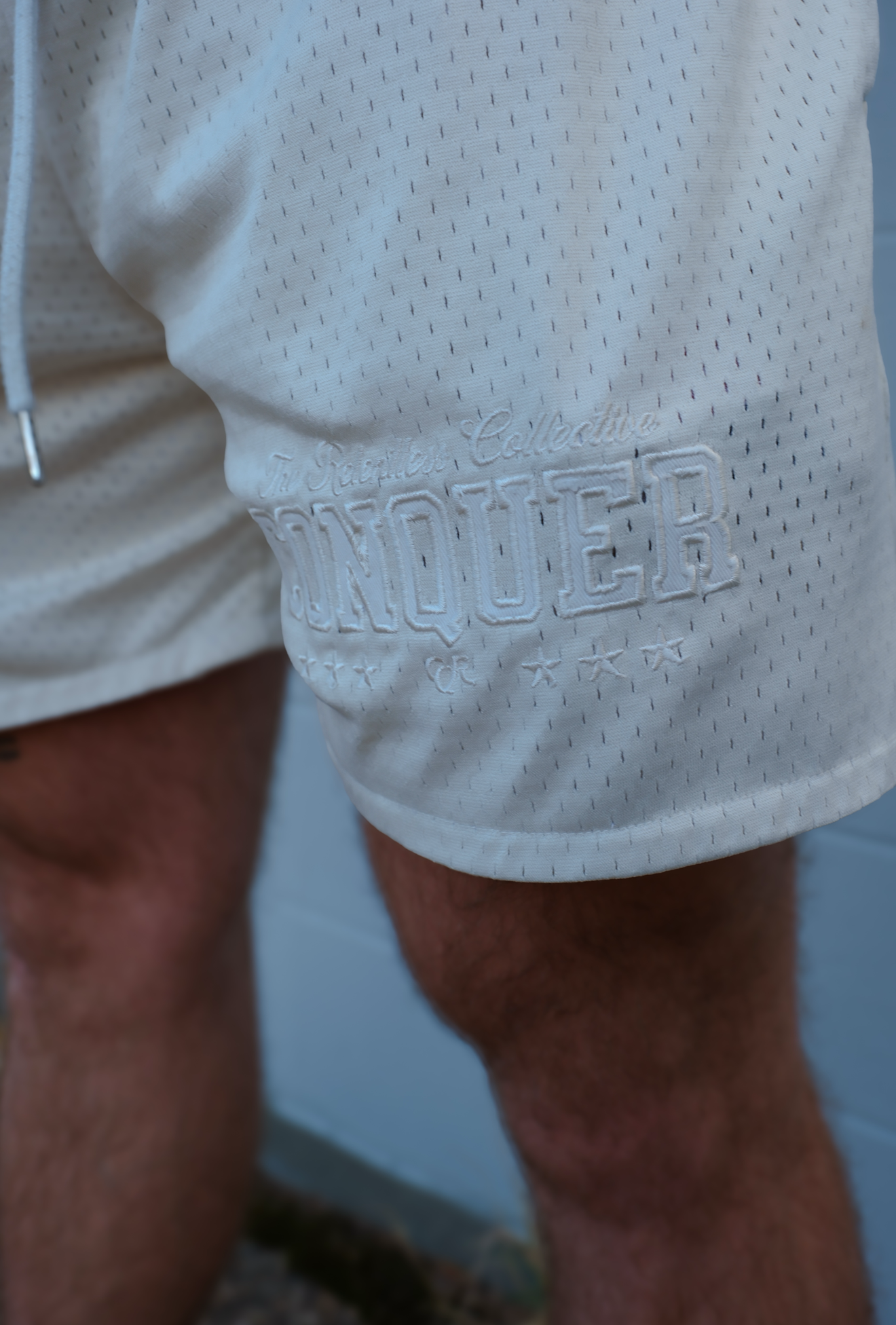 Model wearing Conquer Basketball Shorts on the court